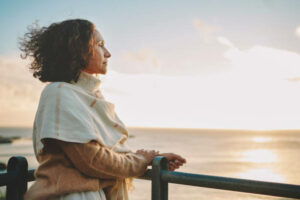 Mature woman looking out to sea.