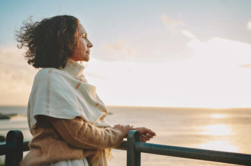 Mature woman looking out to sea.