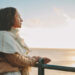 Mature woman looking out to sea.